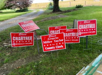 A series of recycled signs with Becky Crabtree's name in white on a red background.