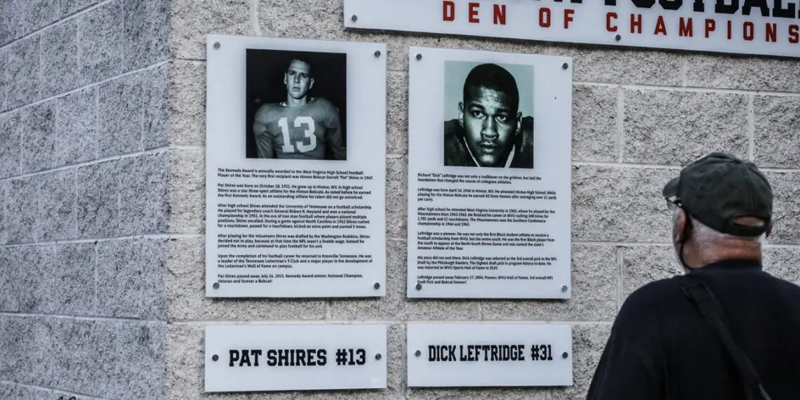 Two signs hang on the wall outside the new Den of Champions.