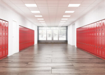 Stock image of a school lobby with red lockers.