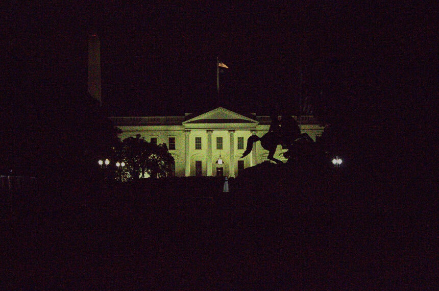 Above, the White House amassed in darkness with the Washington Monument behind