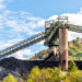 Charleston, West Virginia, USA city with coal mound and industrial factory conveyor belt power plant exterior architecture with elevator lift. Stock image.