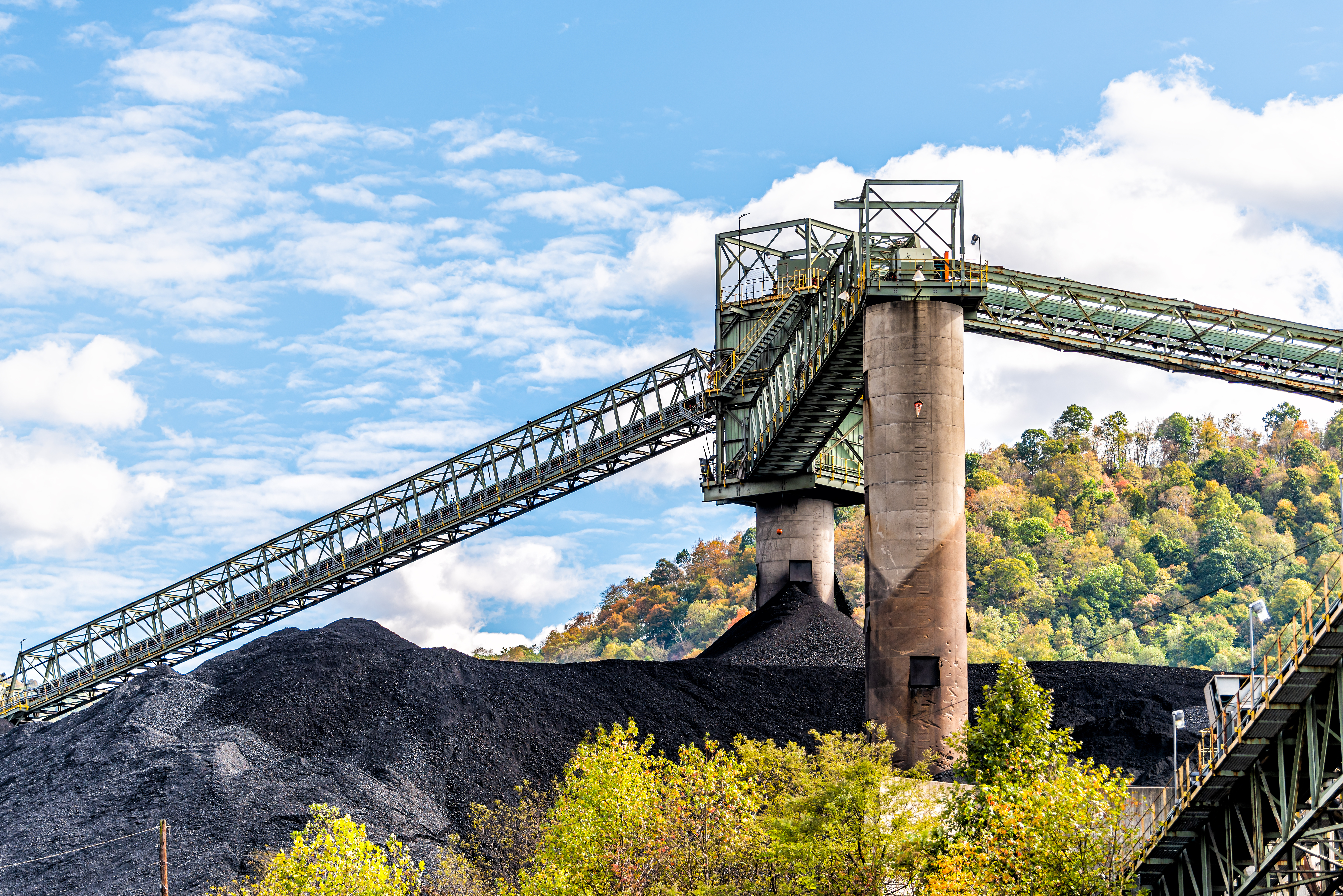 Charleston, West Virginia, USA city with coal mound and industrial factory conveyor belt power plant exterior architecture with elevator lift. Stock image.