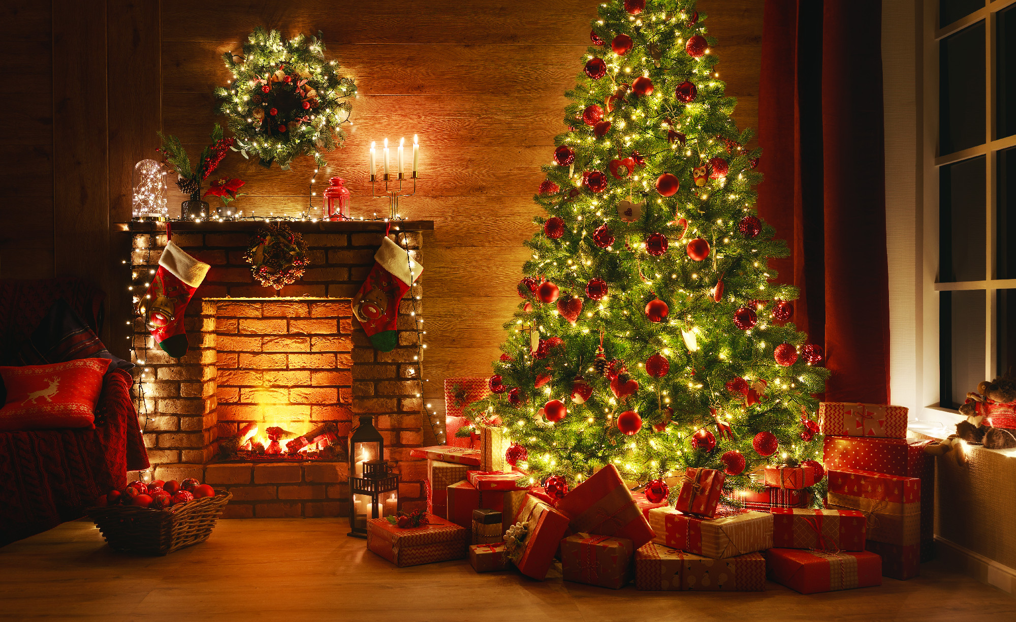 interior christmas. magic glowing tree, fireplace, gifts in dark at night