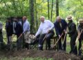 Pictured Left to right: Eric LaPrice, Acting Superintendent, NRGNPP; Tyler Bragg, Interim City Manager, City of Oak Hill; Tyler Ohrn, Field Representative, Office of Congresswoman Carol Miller; Todd Gunter, Economic Development Director, Office of Senator Shelley Moore Capito; Baby Dog; U.S. Senator Jim Justice; WV State Senator Rollan Roberts; Kirsten Talken-Spaulding, Deputy Regional Director, National Park Service; Eve West. Chief of Interpretation, NRGNPP; Lisa Strader, CEO, Visit SWV; Sammy Lee, CEO, Guardian Construction.